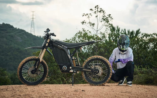 79BIKE Lynx electric dirt bike with rider on a mountain trail